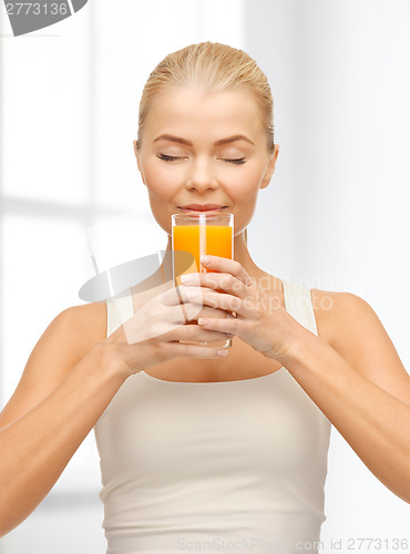 Image of young woman drinking orange juice