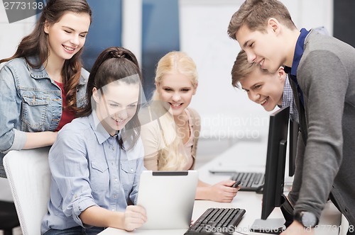 Image of students with computer monitor and tablet pc