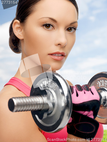 Image of asian sporty woman with heavy dumbbell