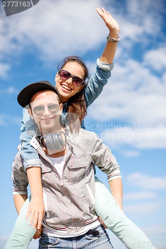 Image of smiling teenagers in sunglasses having fun outside