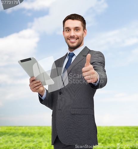 Image of smiling buisnessman with tablet pc computer