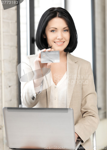 Image of happy woman with credit card