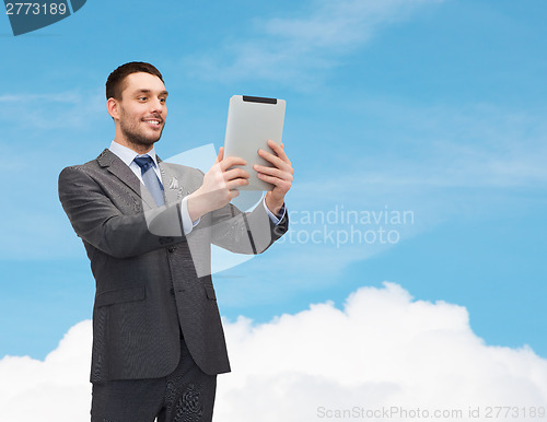 Image of smiling businessman with tablet pc computer