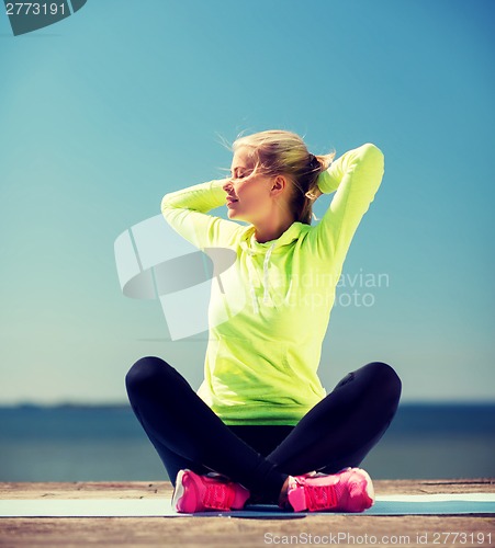 Image of woman doing yoga outdoors