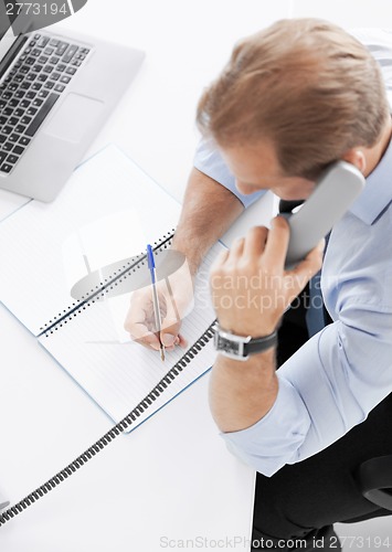 Image of handsome businessman talking on the phone