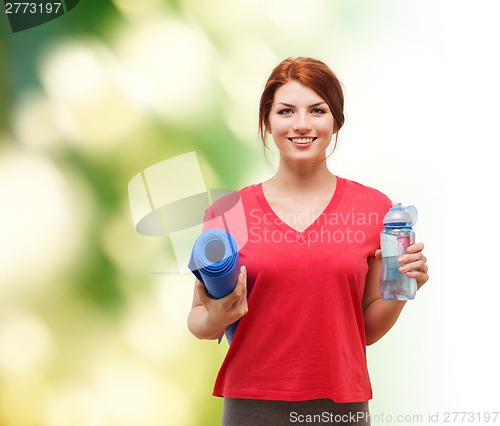 Image of smiling girl with bottle of water after exercising
