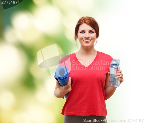 Image of smiling girl with bottle of water after exercising