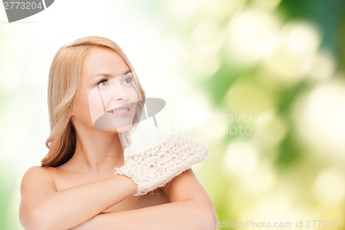 Image of smiling woman with exfoliation glove