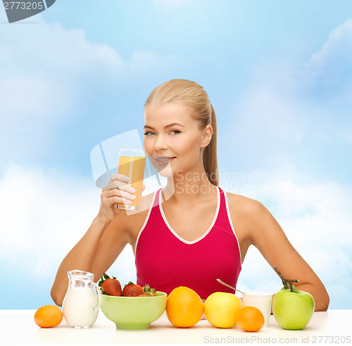 Image of smiling young woman eating healthy breakfast