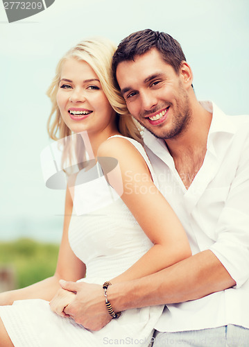 Image of couple in shades at sea side