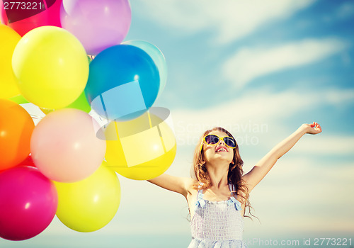 Image of happy girl with colorful balloons