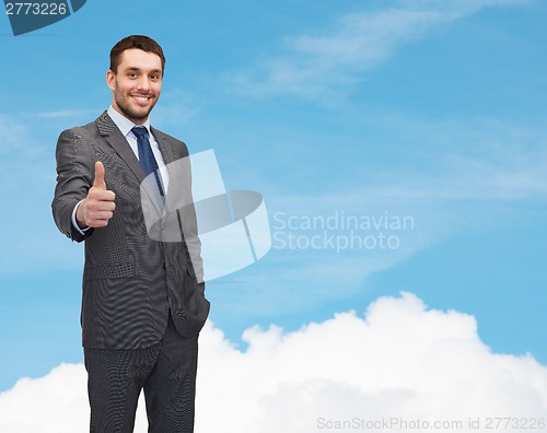 Image of handsome businessman showing thumbs up