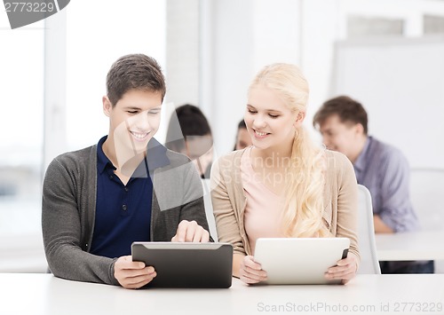 Image of students looking at tablet pc in lecture at school