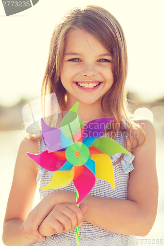 Image of happy girl with colorful pinwheel toy