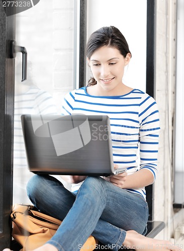 Image of happy teenage girl with laptop computer