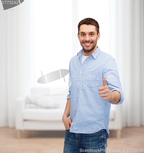 Image of smiling man showing thumbs up