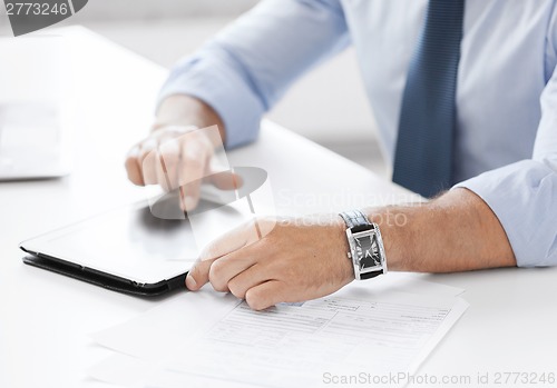 Image of businessman with tablet pc in office