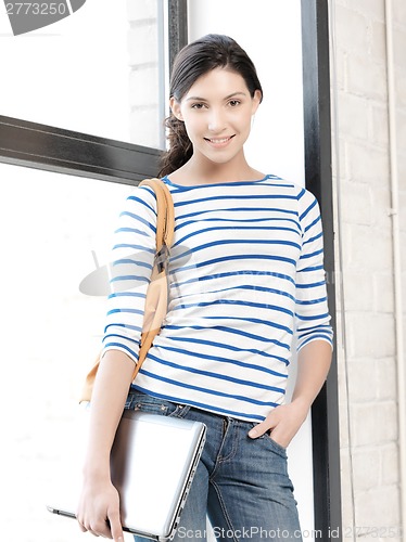 Image of happy and smiling teenage girl with laptop