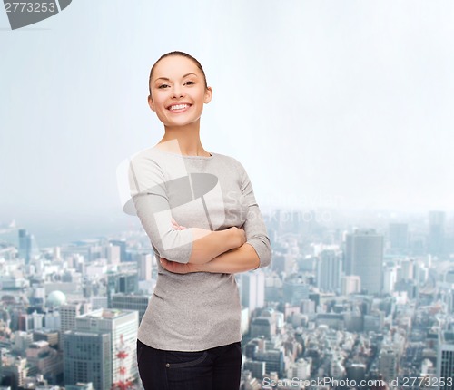 Image of smiling asian woman over with crossed arms