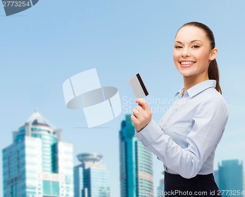 Image of smiling businesswoman showing credit card