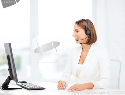 Image of friendly female helpline operator with computer