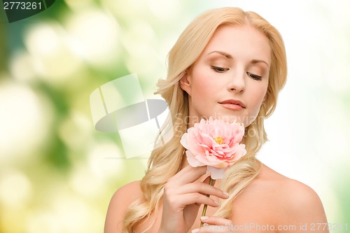 Image of lovely woman with peony flower