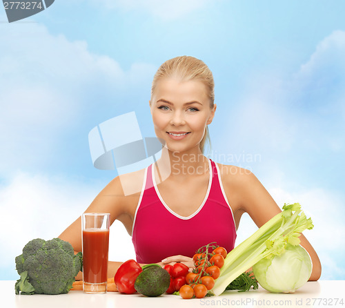 Image of smiling young woman with organic food on the table