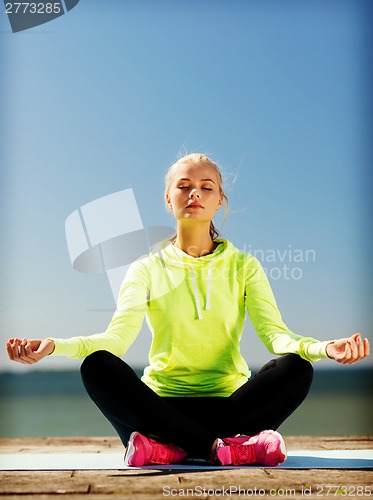 Image of woman doing yoga outdoors