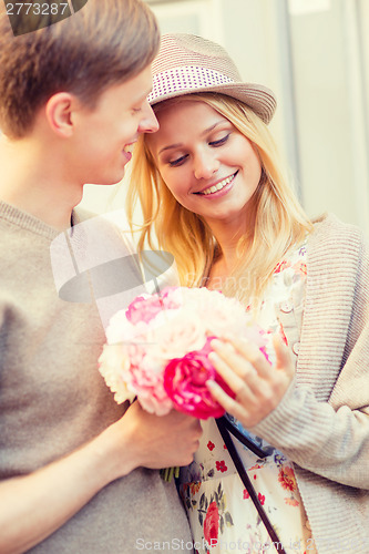 Image of couple with flowers in the city