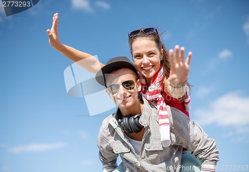Image of smiling teenagers in sunglasses having fun outside
