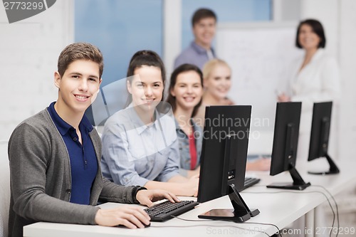 Image of students with computer monitor at school