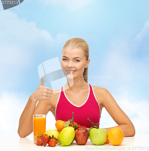 Image of smiling woman with organic food or fruits on table