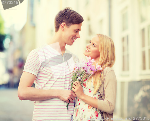 Image of couple with flowers in the city