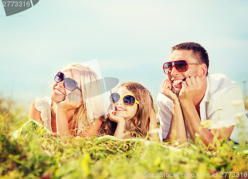Image of happy family with blue sky and green grass
