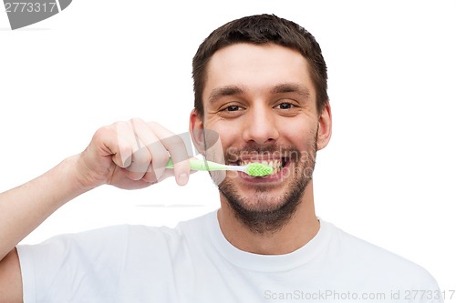 Image of smiling young man with toothbrush