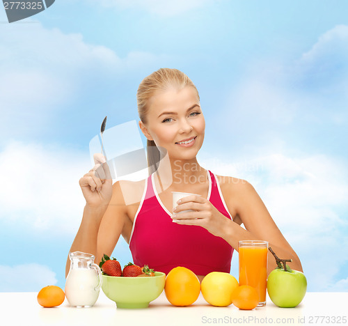 Image of young woman eating healthy breakfast