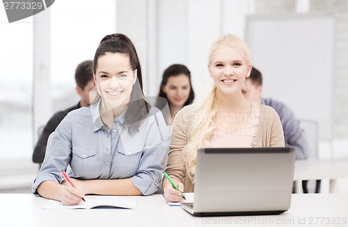 Image of students with laptop and notebooks at school