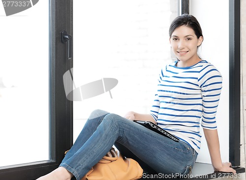 Image of happy and smiling teenage girl with laptop