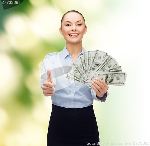 Image of young businesswoman with dollar cash money