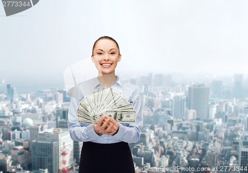 Image of young businesswoman with dollar cash money