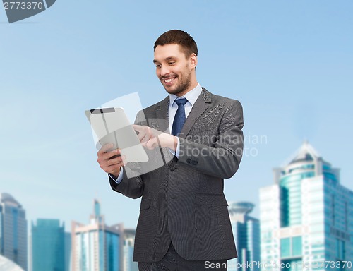Image of smiling businessman with tablet pc computer