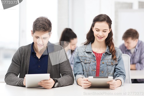 Image of students looking at tablet pc in lecture at school