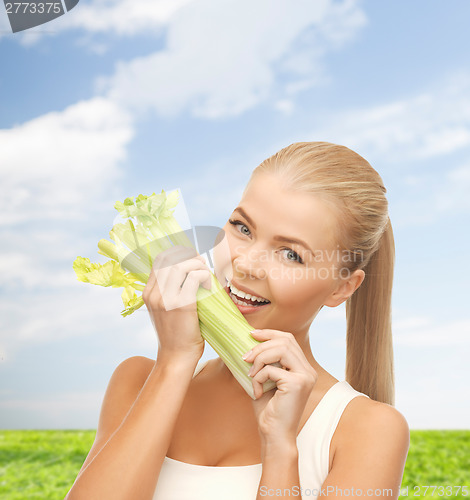 Image of woman biting piece of celery or green salad