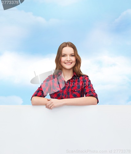 Image of smiling young teenage girl with white blank board