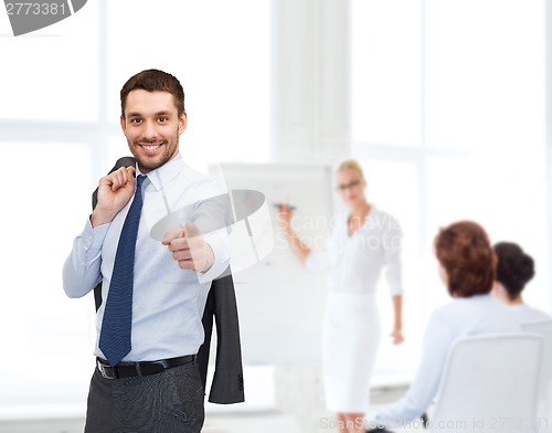 Image of handsome buisnessman with jacket over shoulder