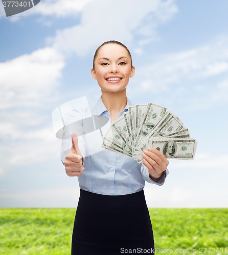 Image of young businesswoman with dollar cash money