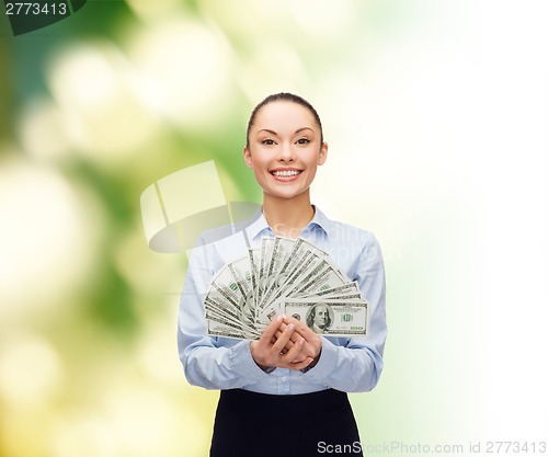 Image of young businesswoman with dollar cash money