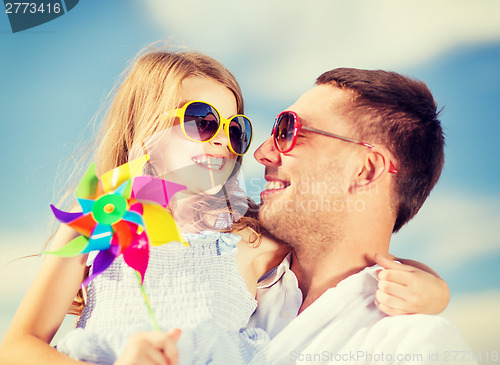 Image of happy father and child in sunglasses over blue sky