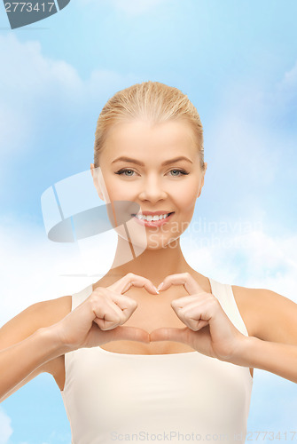 Image of smiling woman showing heart shape gesture