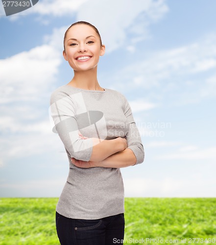 Image of smiling asian woman over with crossed arms